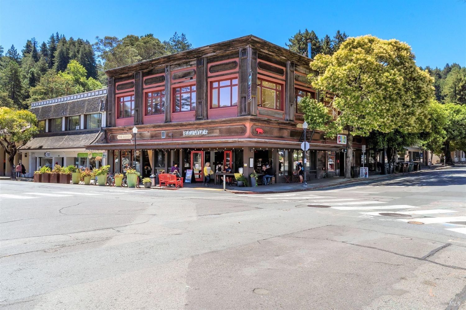 a view of street with retail shops