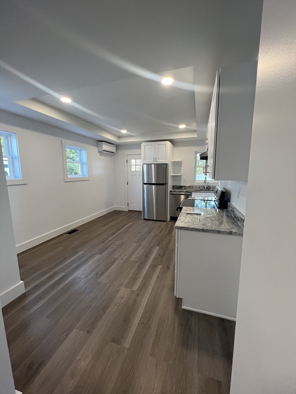 a room with wooden floor and window