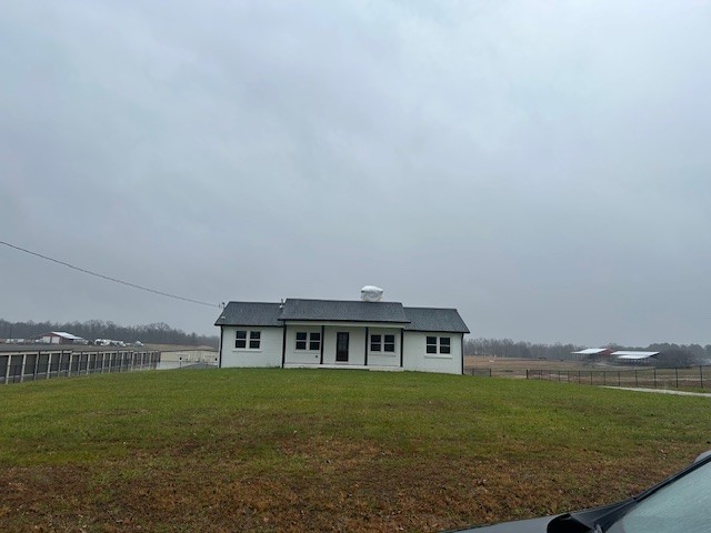 a view of a big house with a big yard and large trees