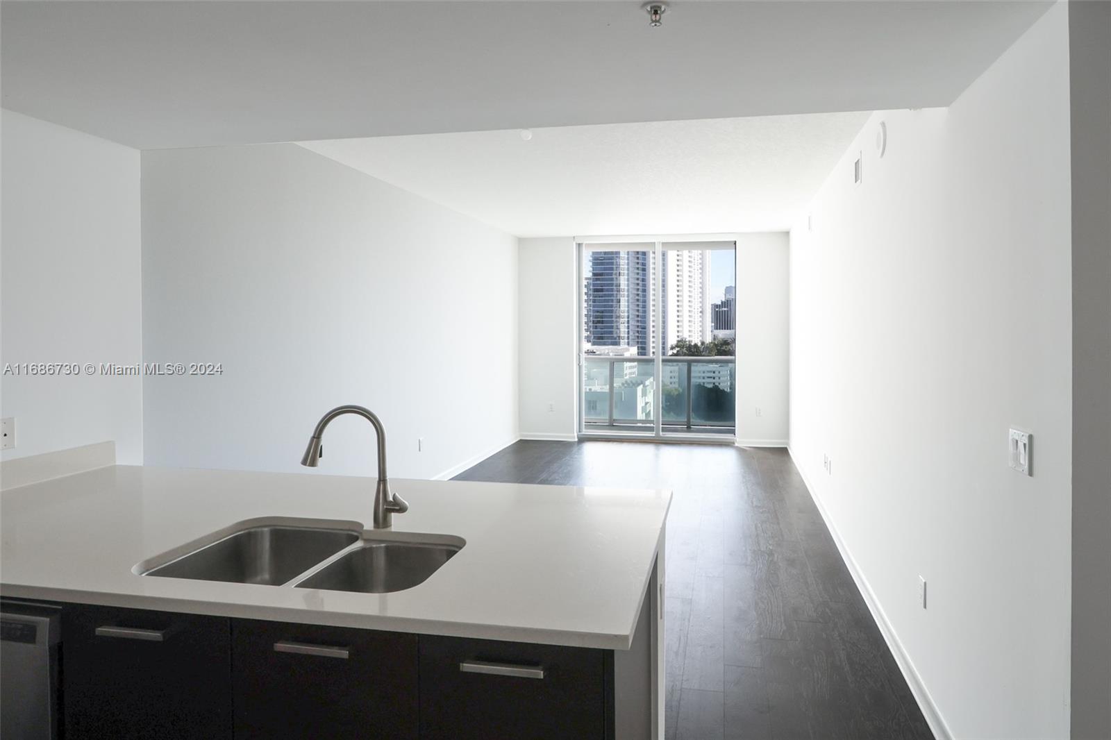 a kitchen with a sink and chandelier