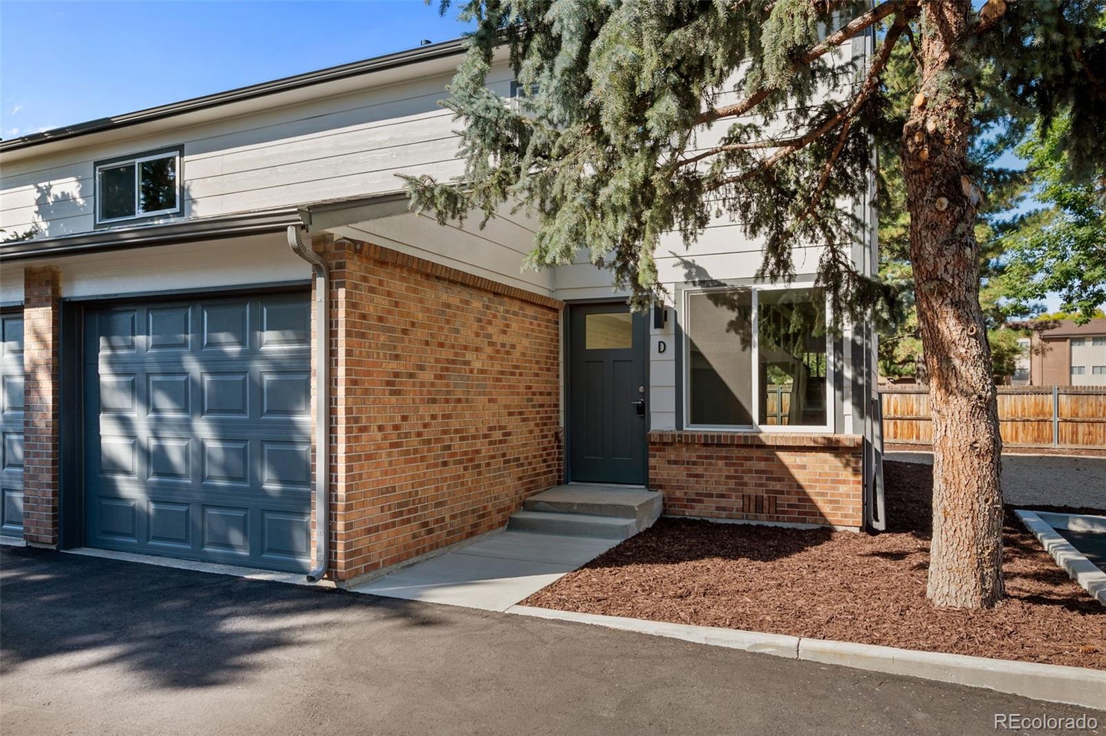 a front view of a house with garage