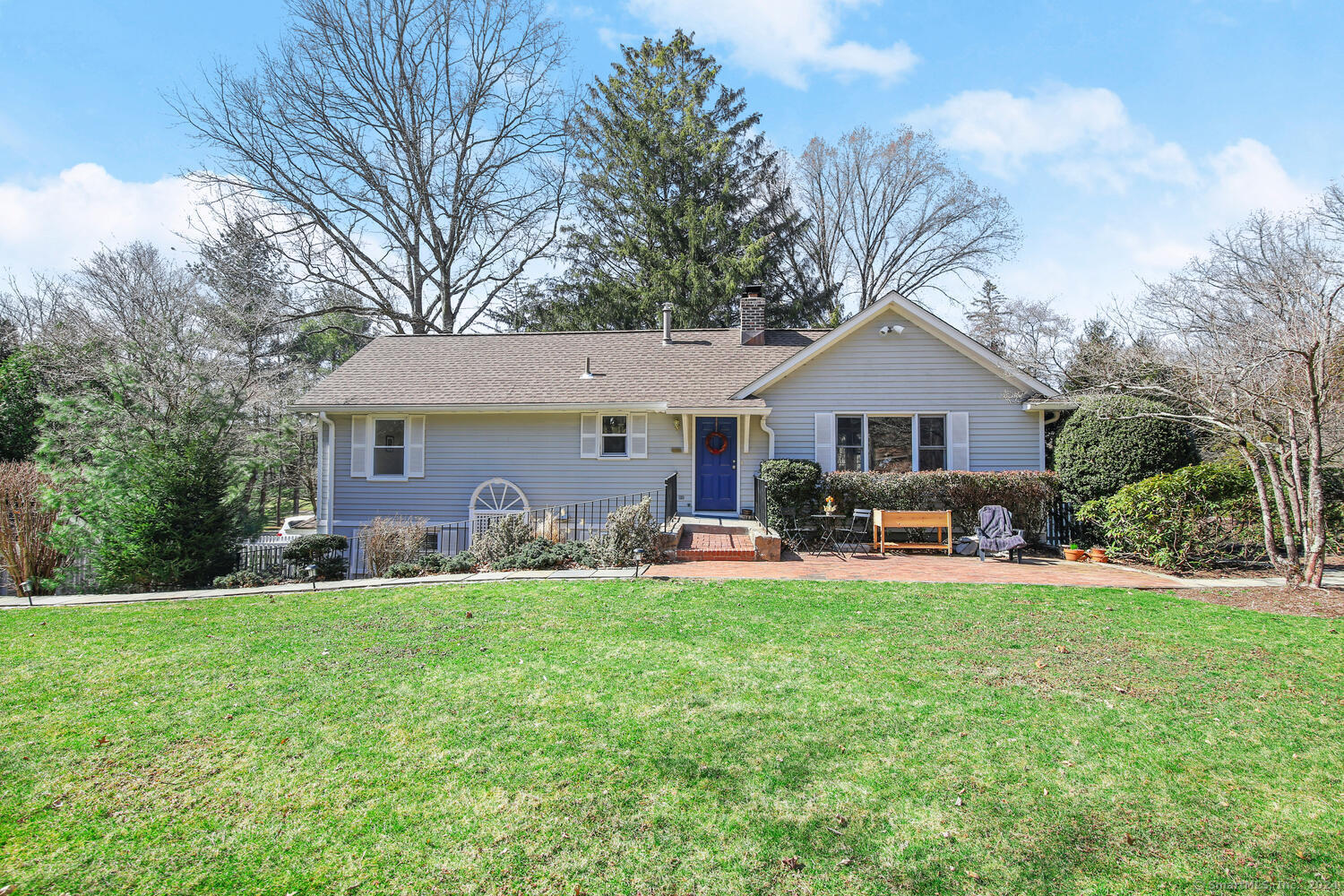 a front view of house with yard patio and green space