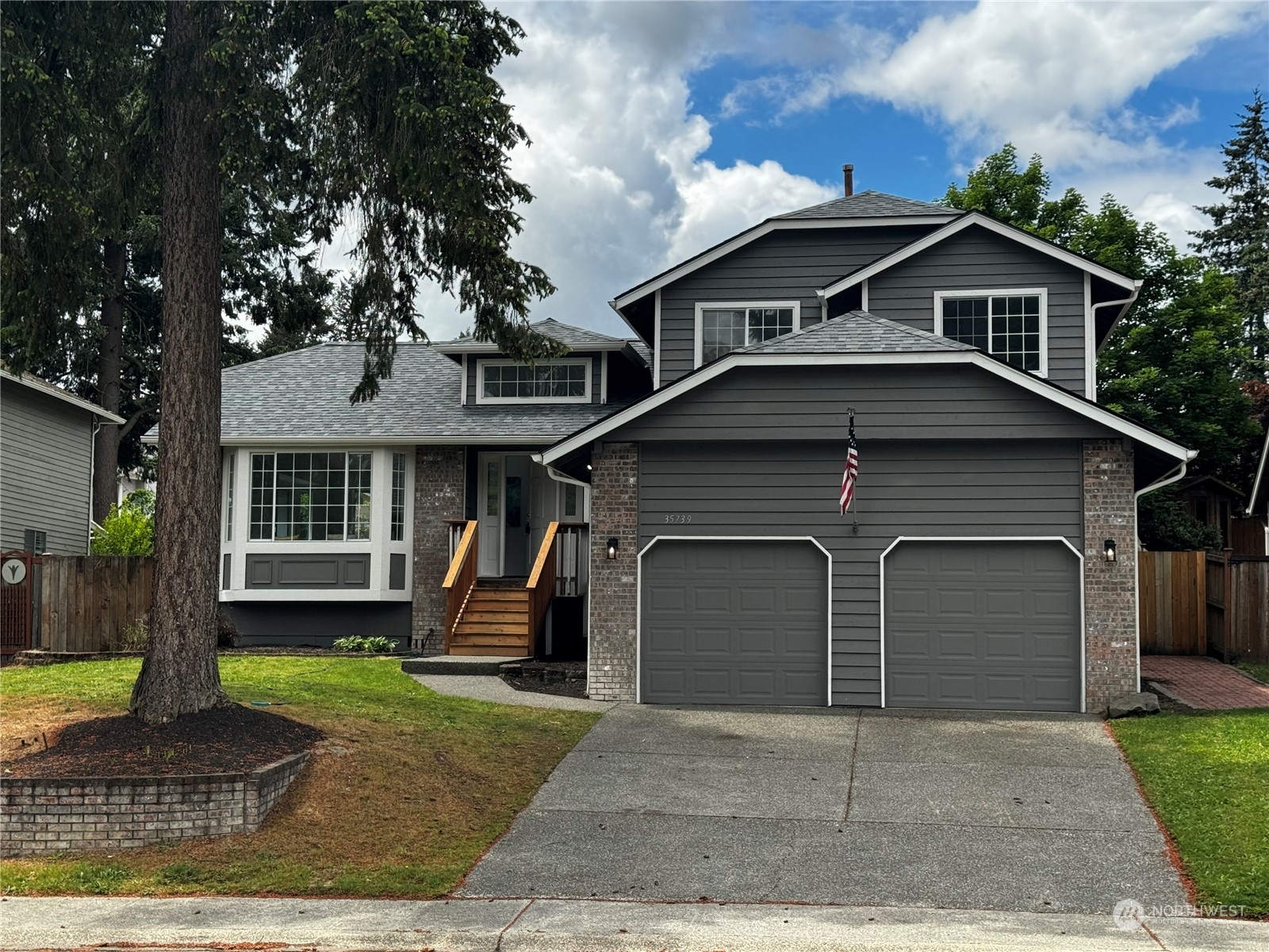 a front view of a house with a yard and garage