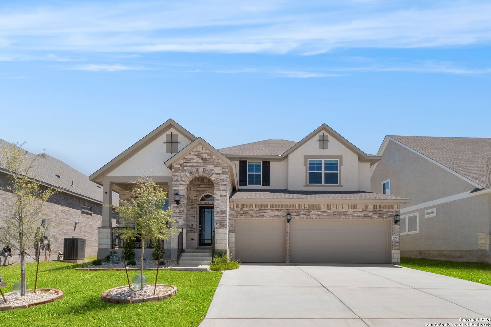 a front view of a house with a yard and garage