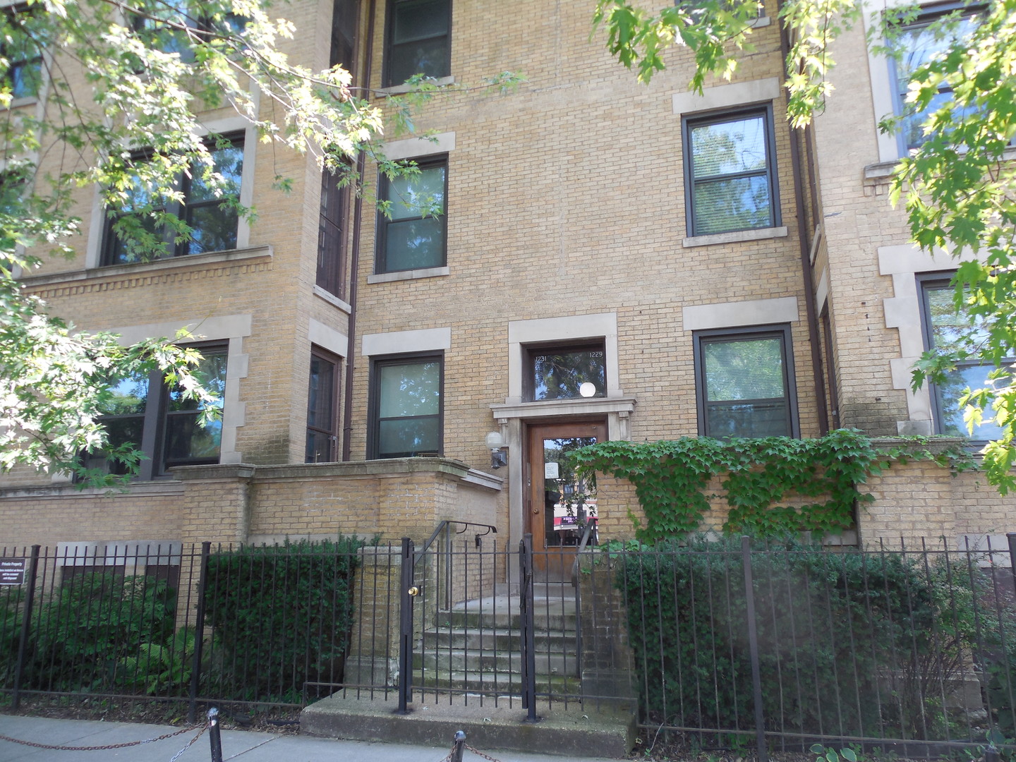 a front view of a house with plants