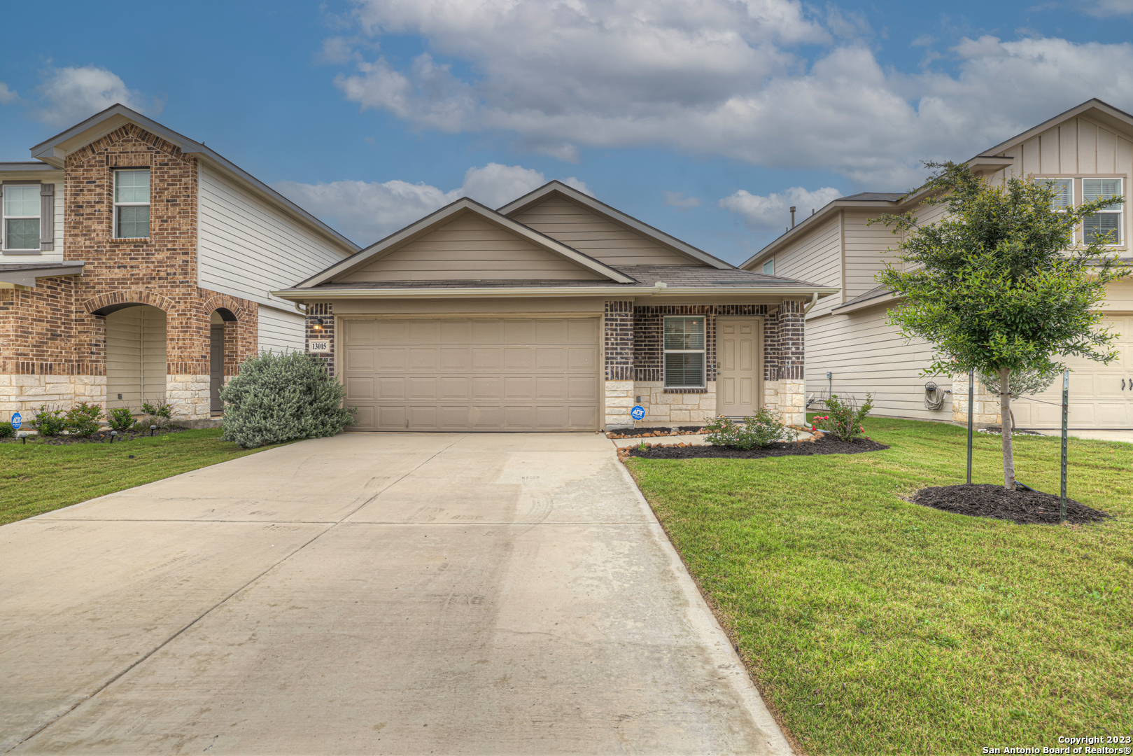 a front view of a house with a yard and garage