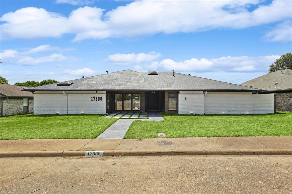 a view of a yard in front view of a house