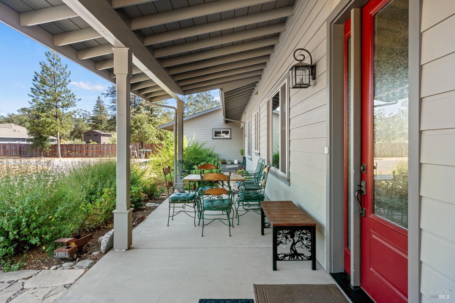 Front porch entry with beautiful tall front door and sidelight.