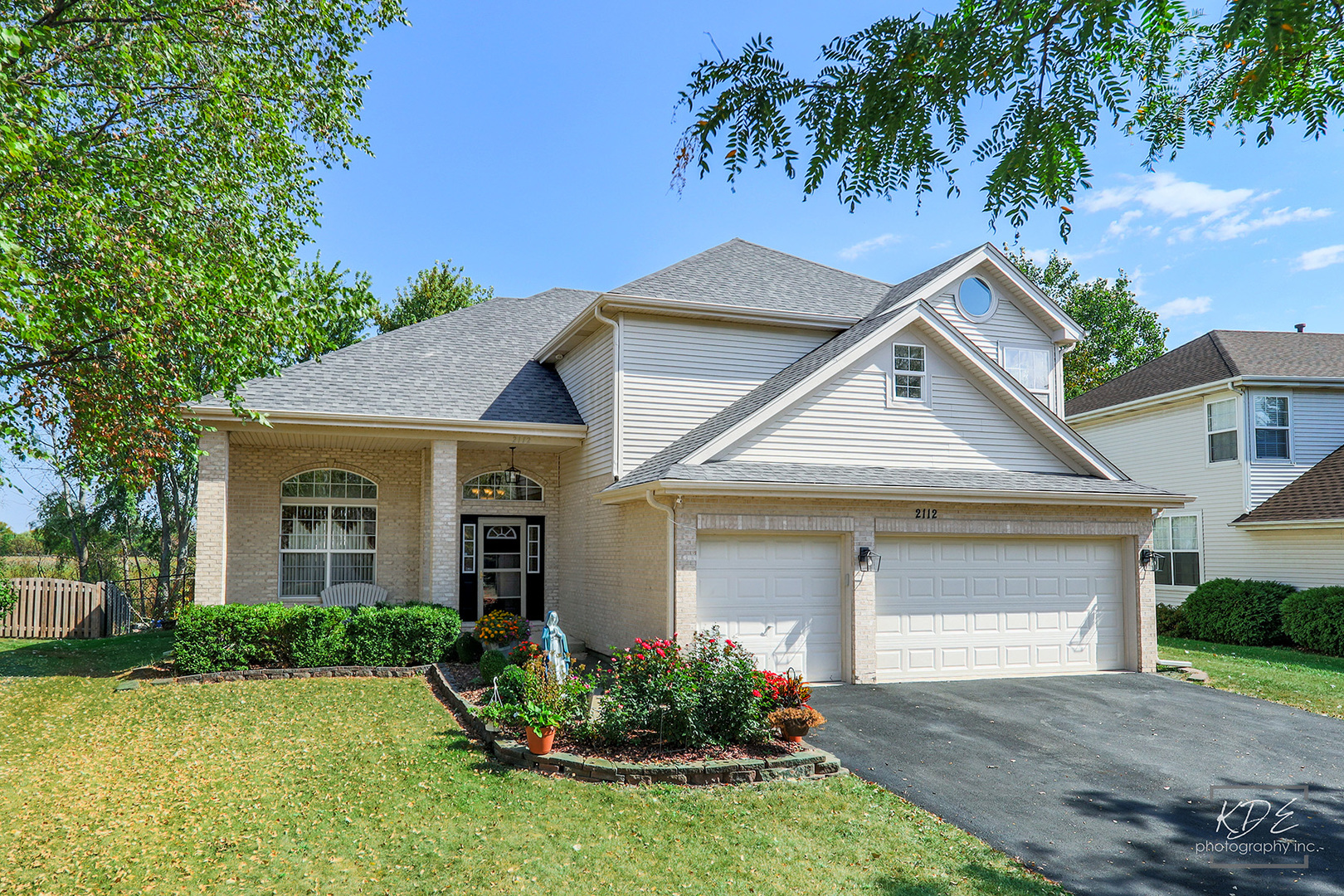 a front view of a house with a garden and yard