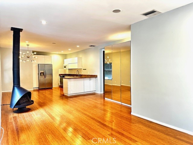 a view of a kitchen with a refrigerator and a sink