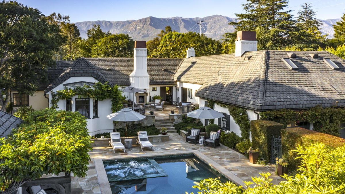 an aerial view of a house with swimming pool and patio