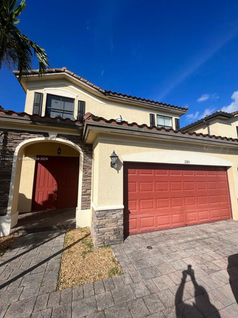 a front view of a house with a garage