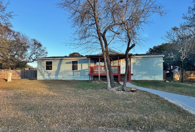 a view of a house with a yard and tree