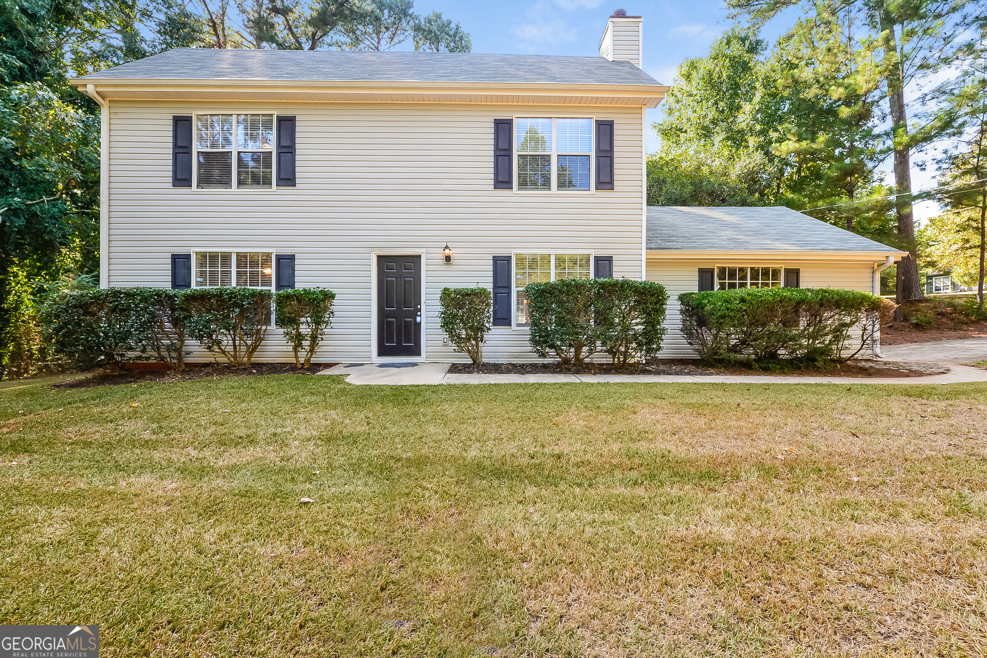 a front view of a house with garden