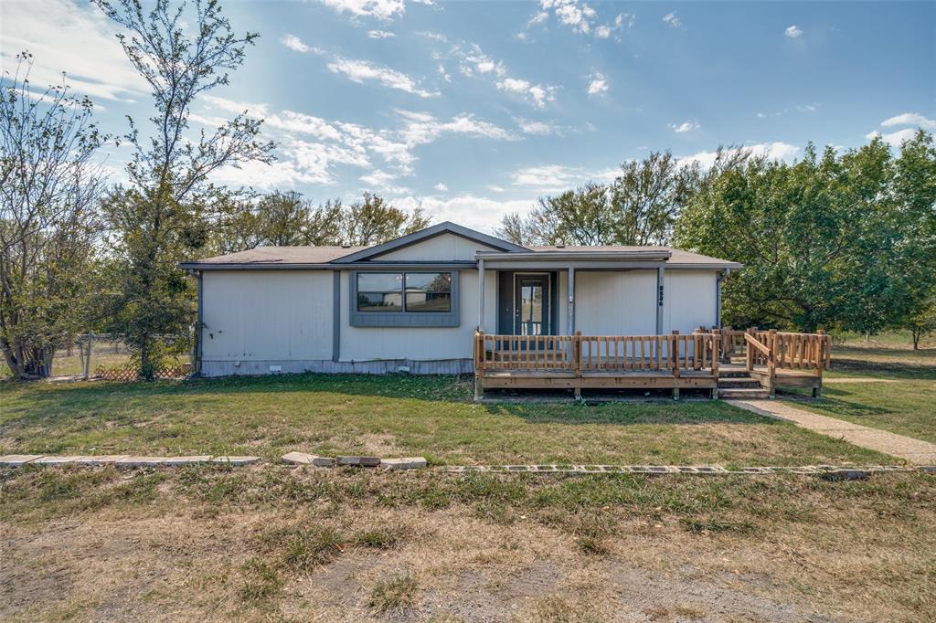 a view of a house with a yard and fence