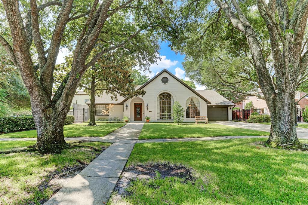 Pretty as a picture, this West U home sits on a large 11200sf lot and is tucked under a mature leafy canopy.