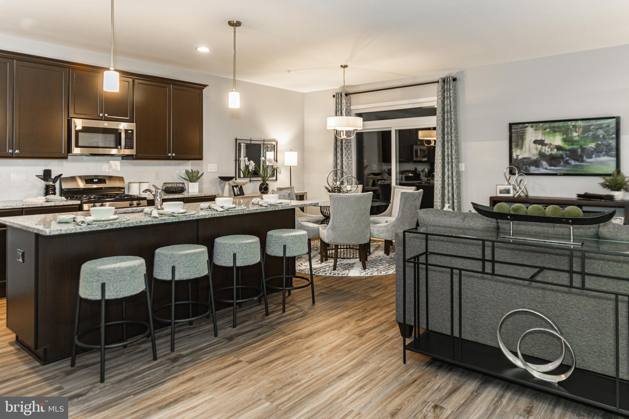 a kitchen with a table chairs stove and microwave