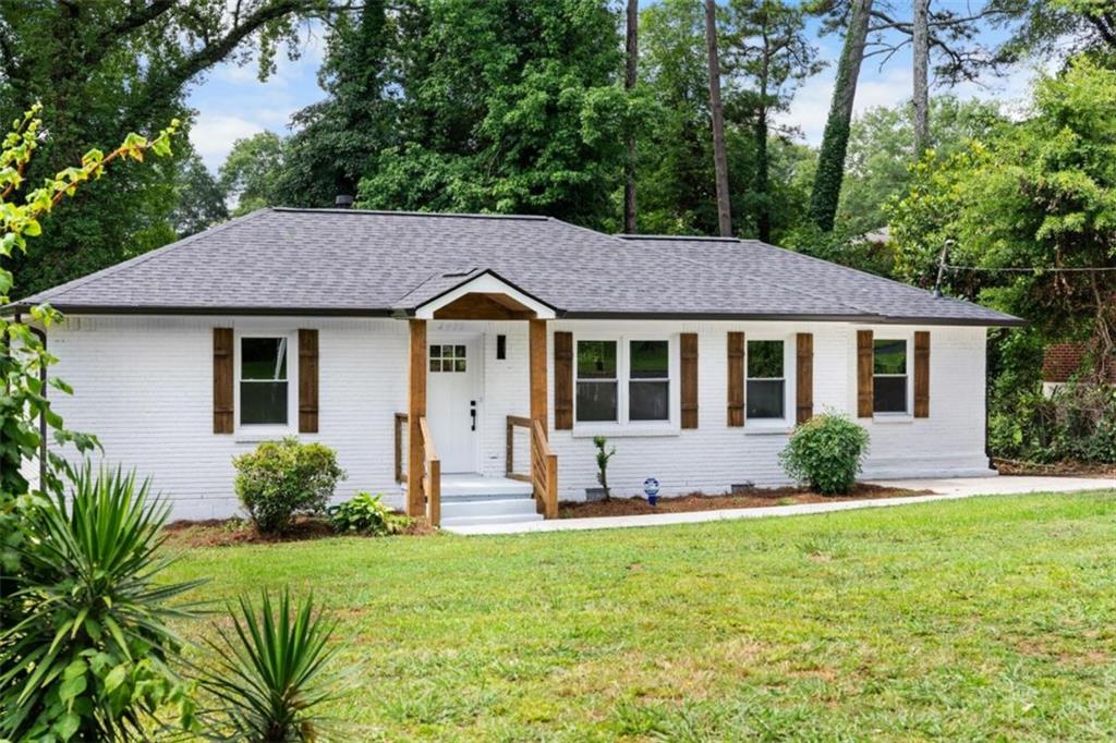 a front view of a house with yard and green space