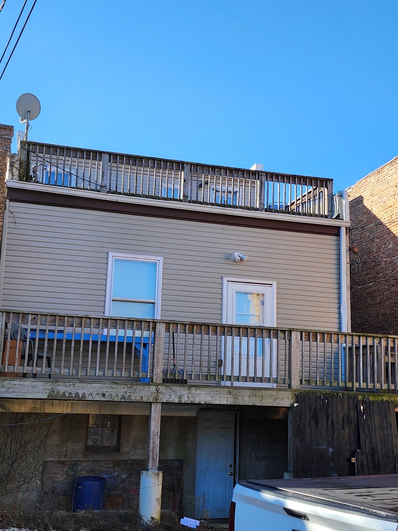 a roof deck with wooden floor and fence