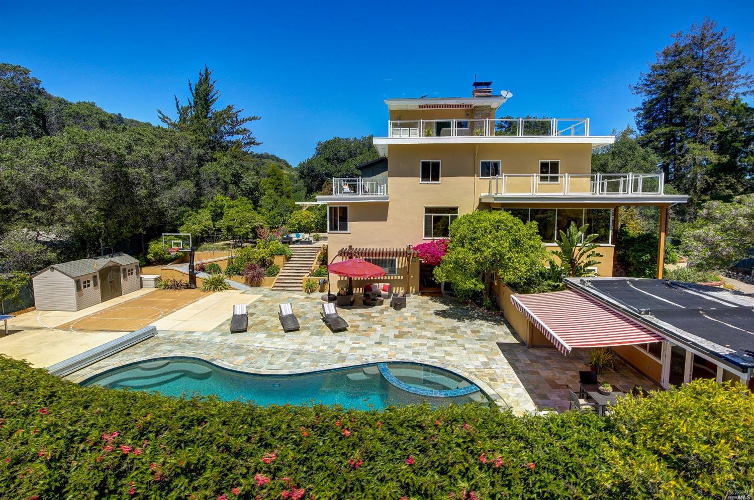 a view of a house with pool and chairs