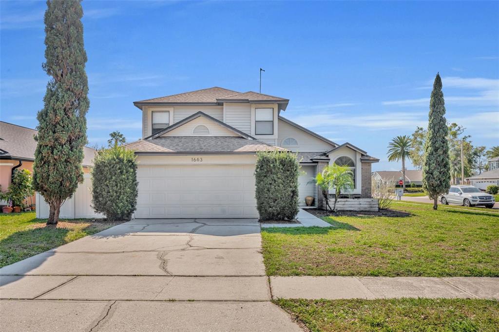 a front view of a house with a yard and garage