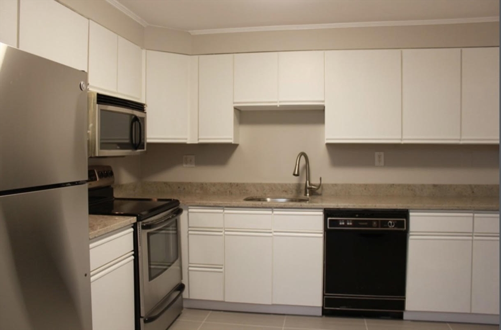 a kitchen with a sink stove and refrigerator