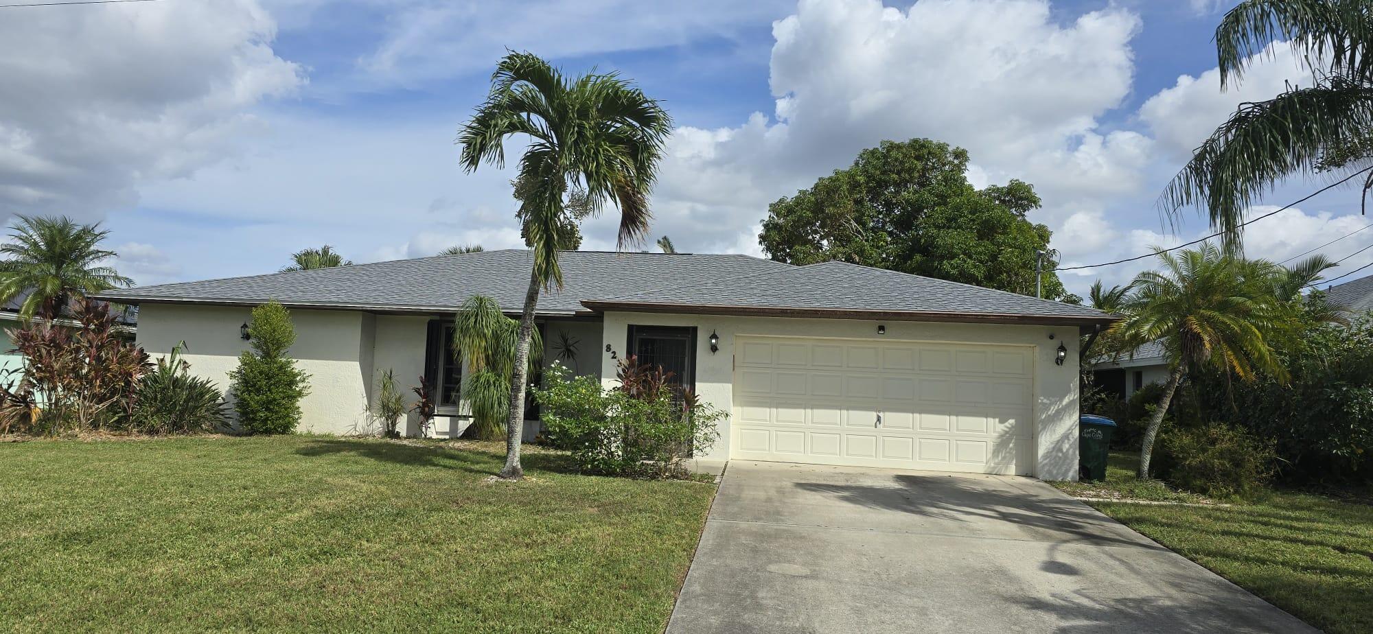 a front view of a house with a garden