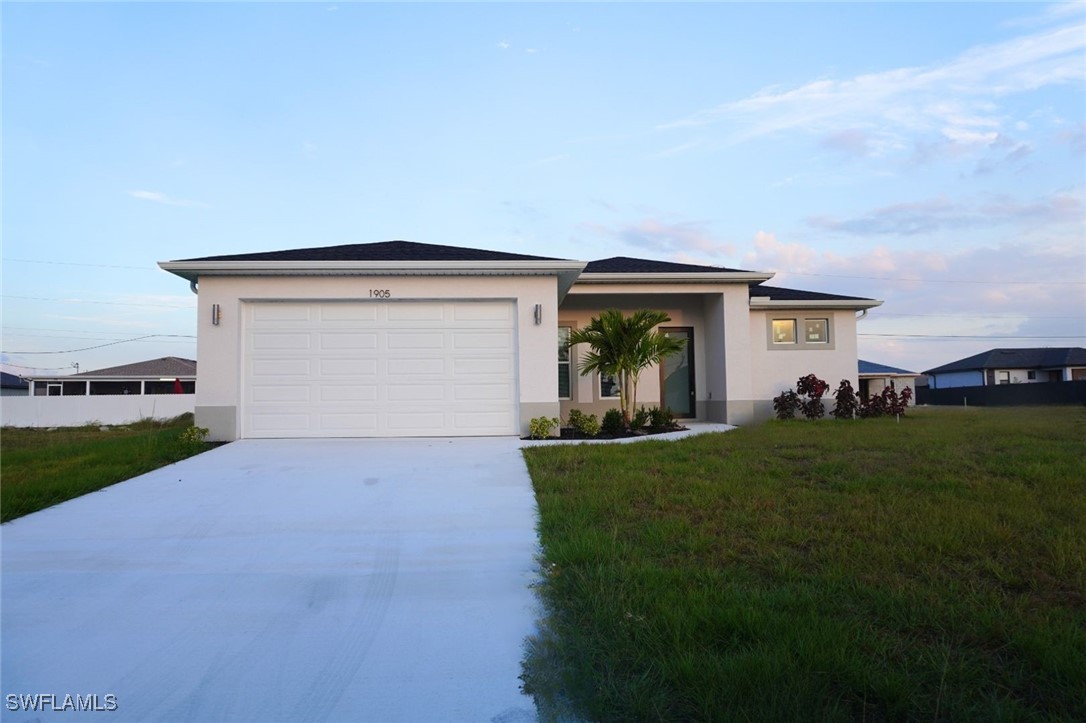 a view of a house with a yard and garage