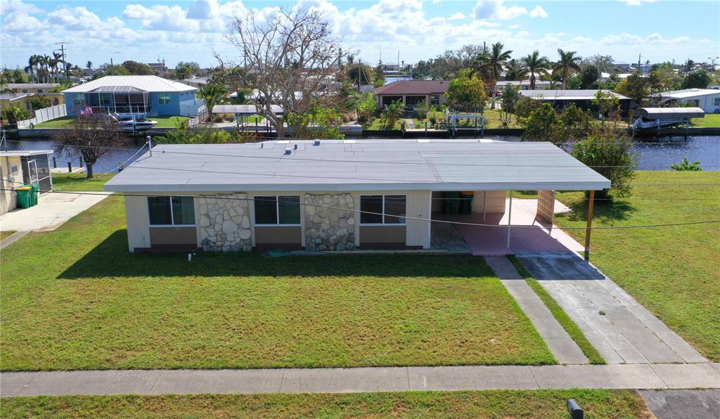 a aerial view of a house with swimming pool and a yard