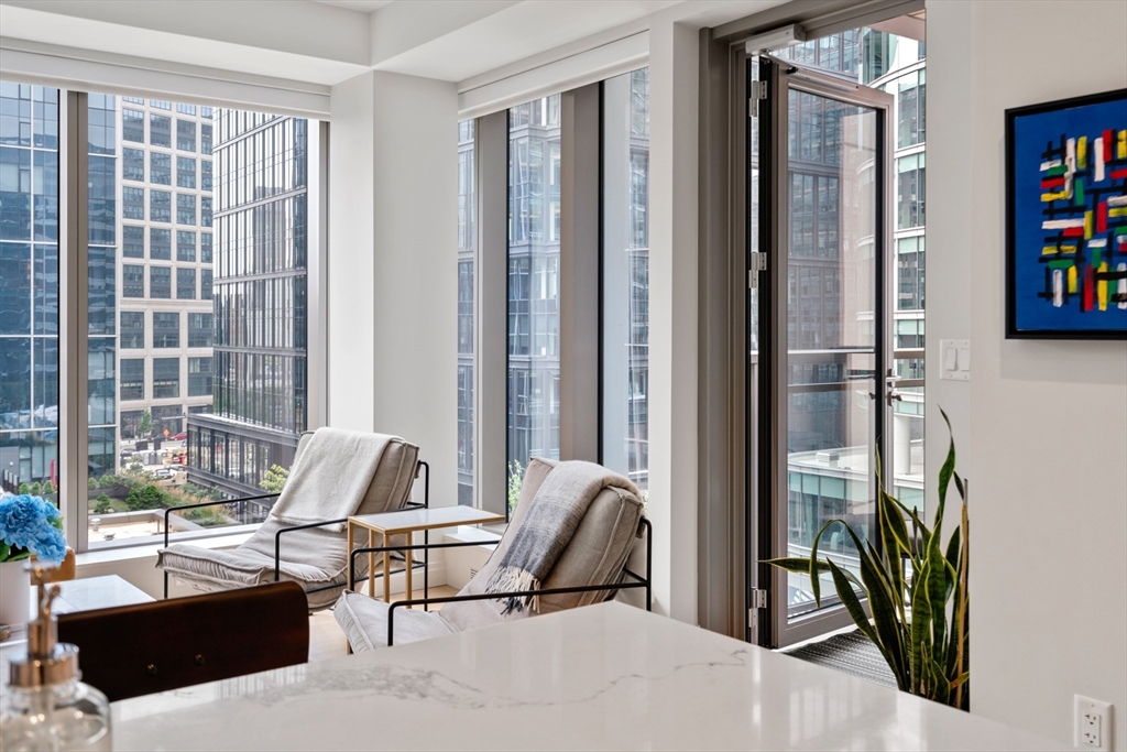 a view of a workspace with a window and lounge chair