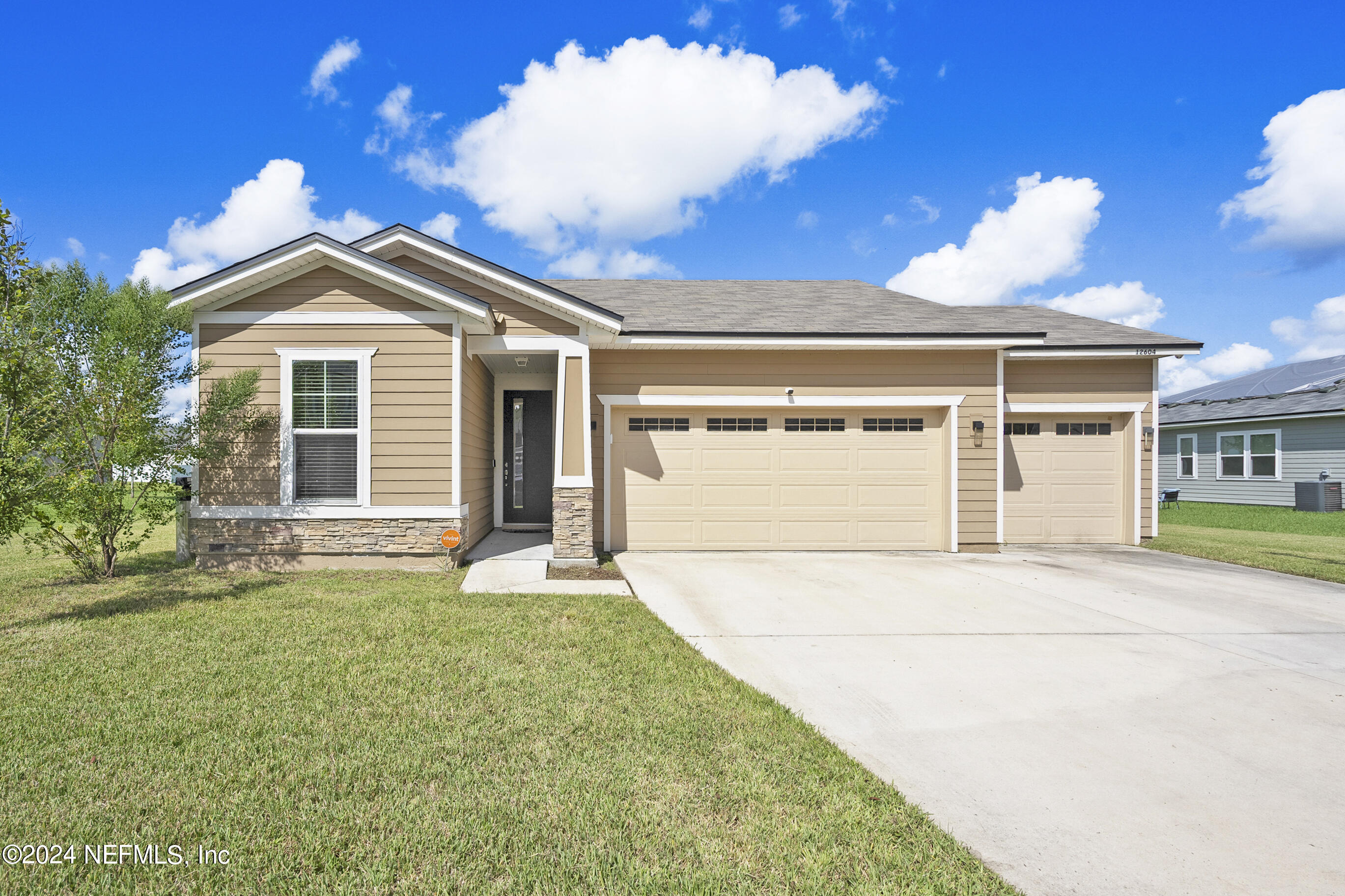 a front view of a house with a yard and garage