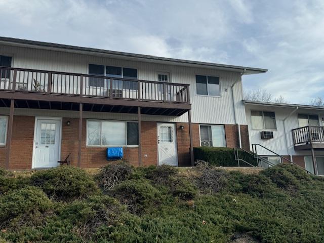 Back of property featuring a balcony