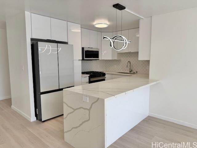 a kitchen with cabinets and stainless steel appliances