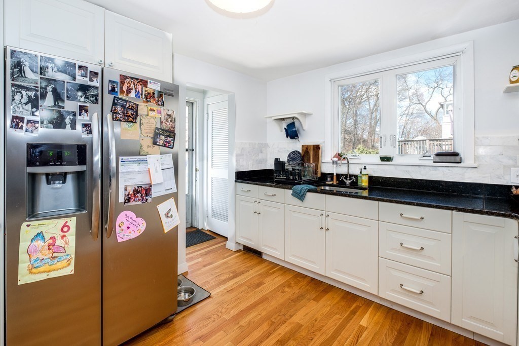 a kitchen with stainless steel appliances granite countertop a refrigerator and a stove