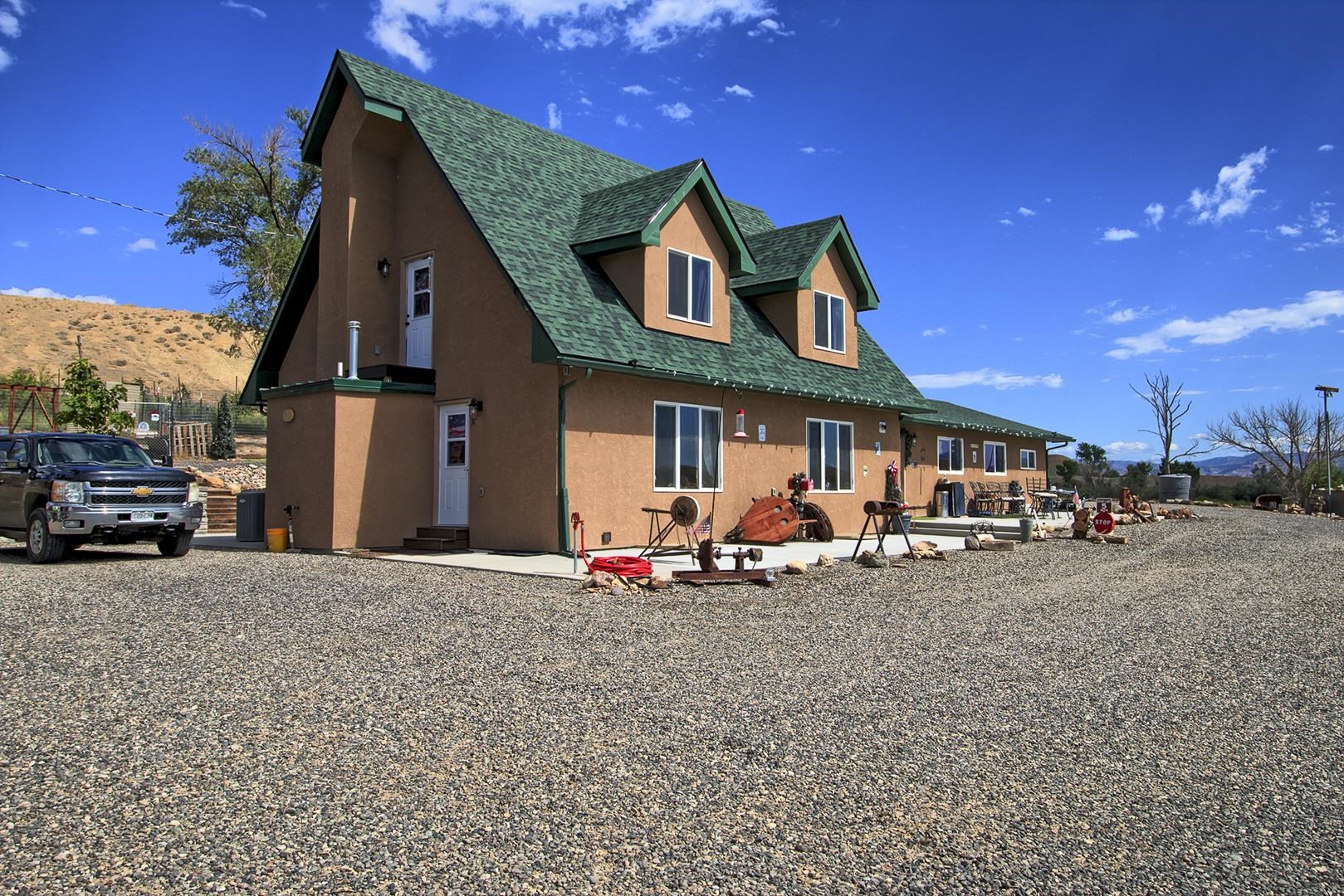 a view of a house with a yard patio and fire pit