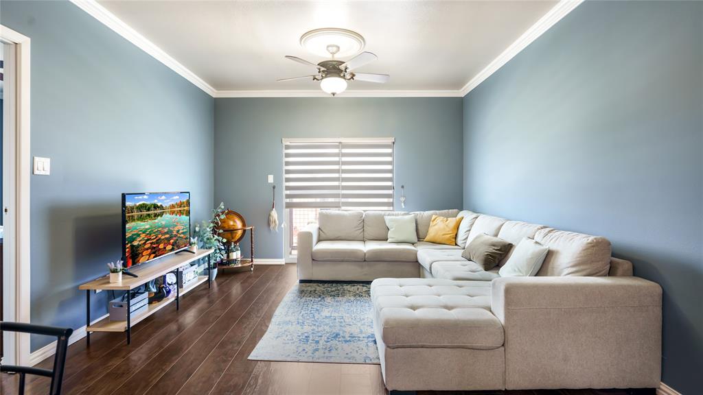 a living room with furniture and a chandelier