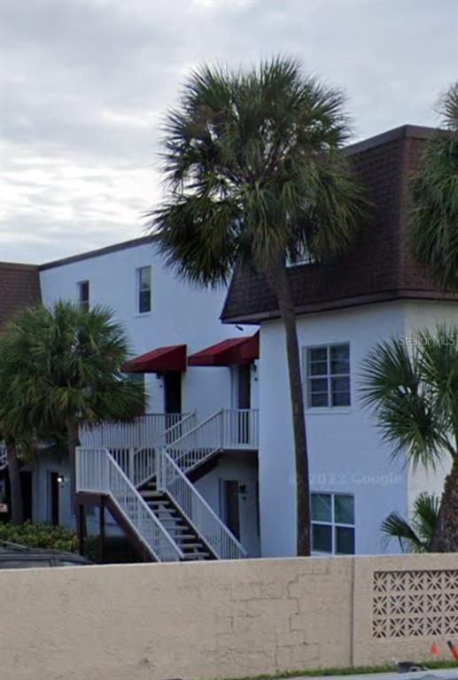 a view of house with a palm tree