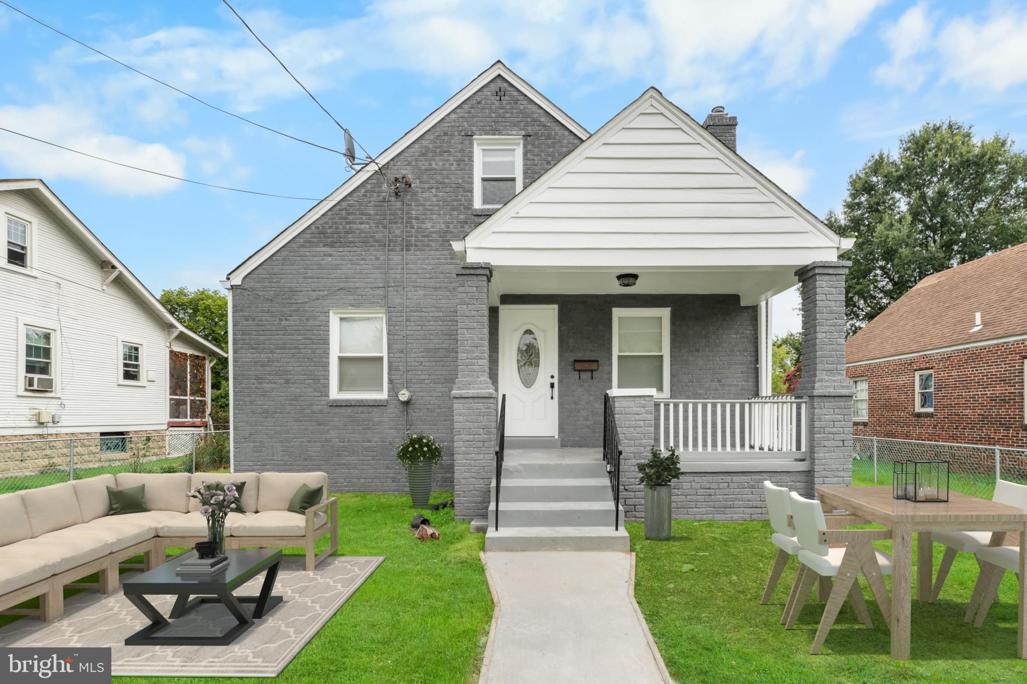 a view of a house with a yard and furniture