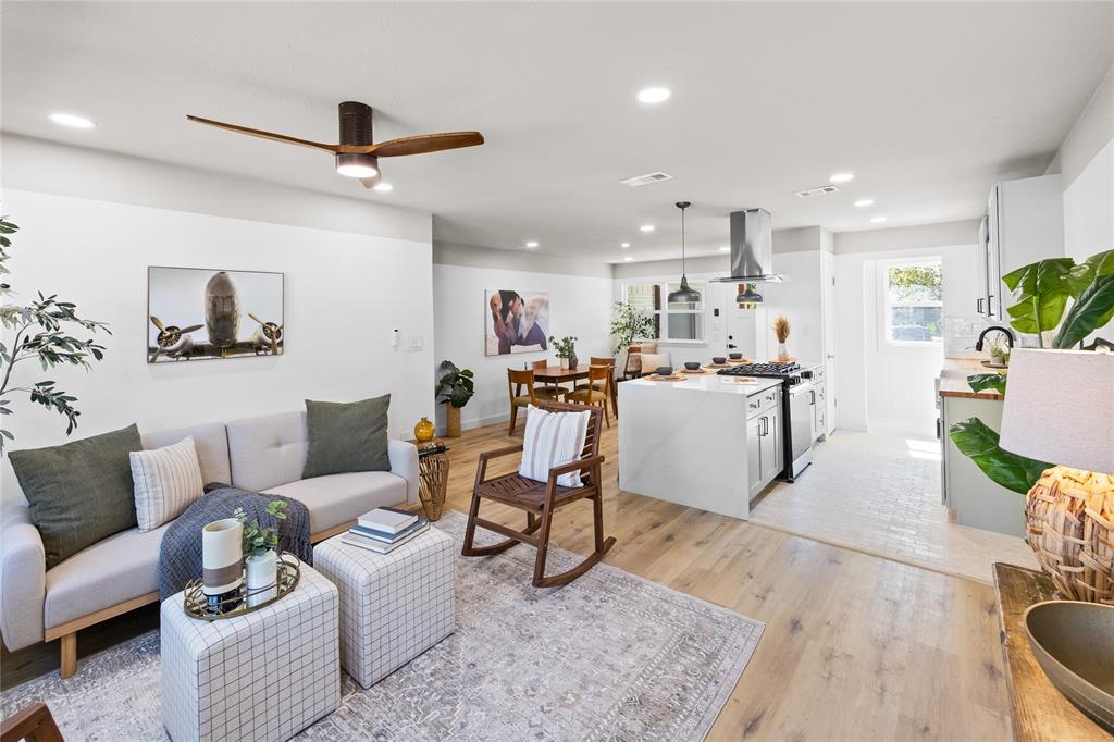 a living room with furniture and kitchen view