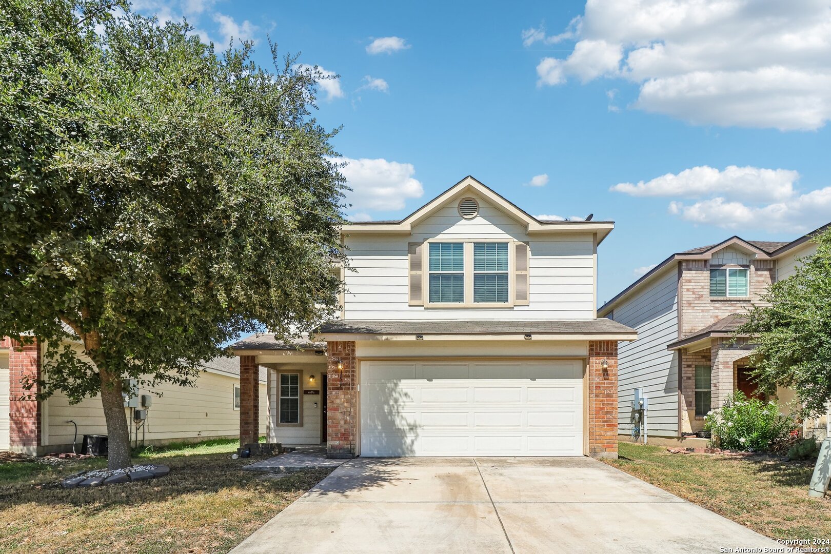 a front view of a house with a yard