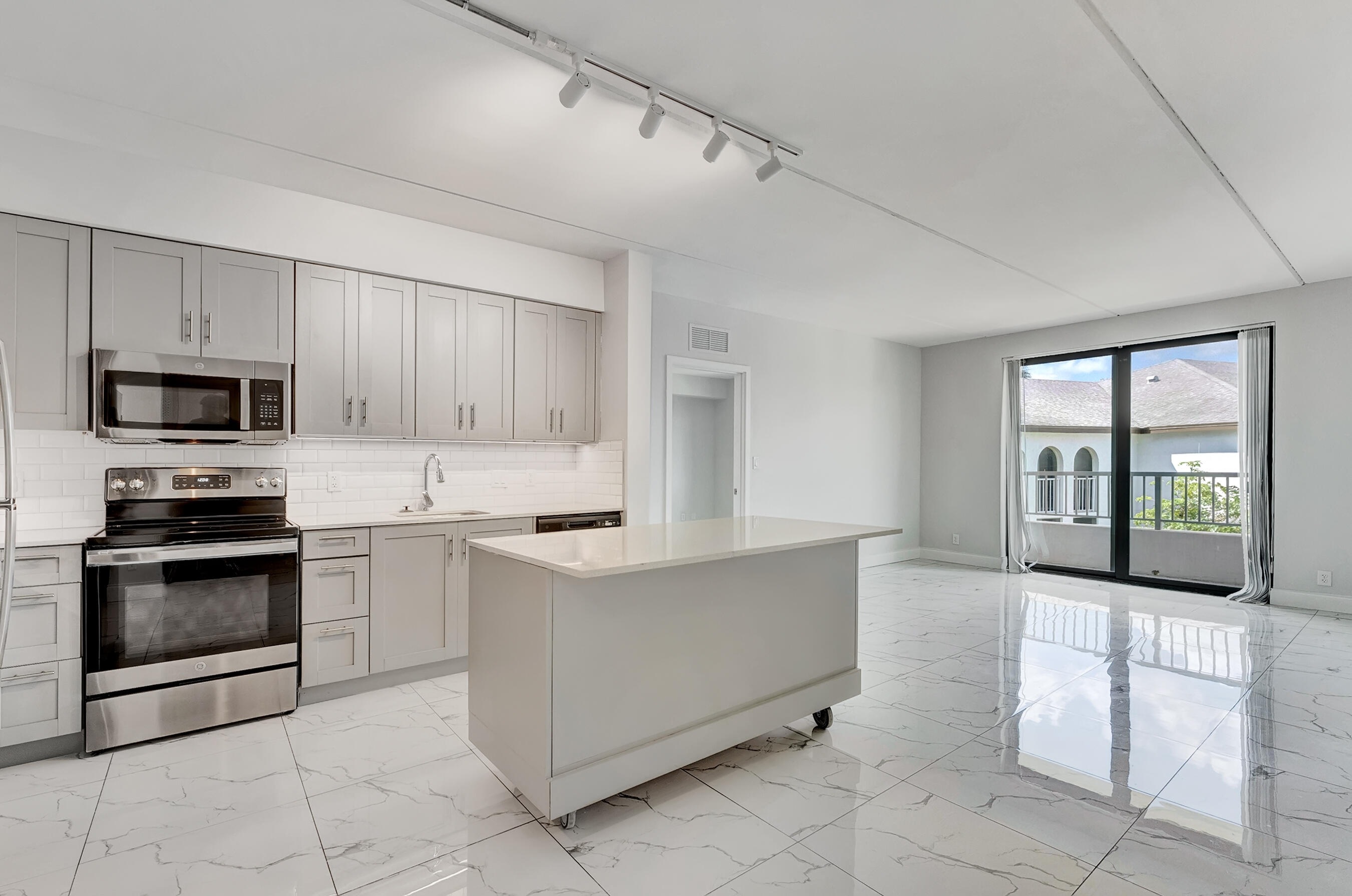 a kitchen with granite countertop a stove and a microwave