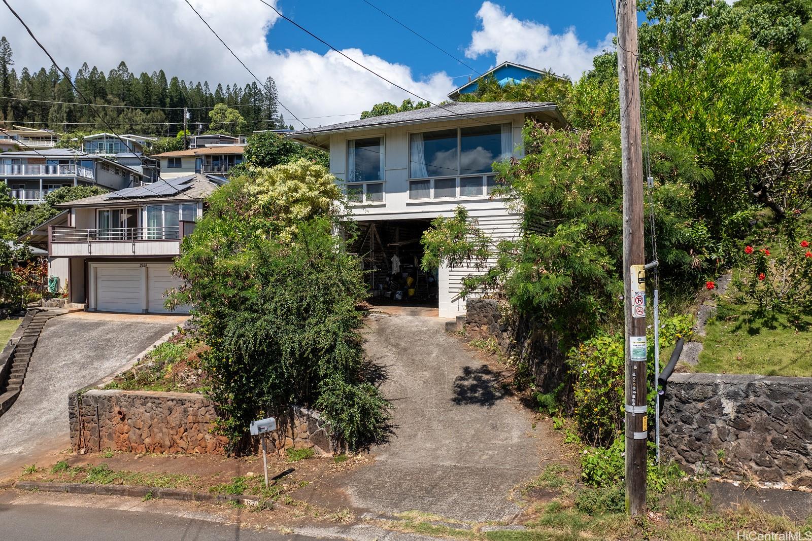 a front view of a house with a garden