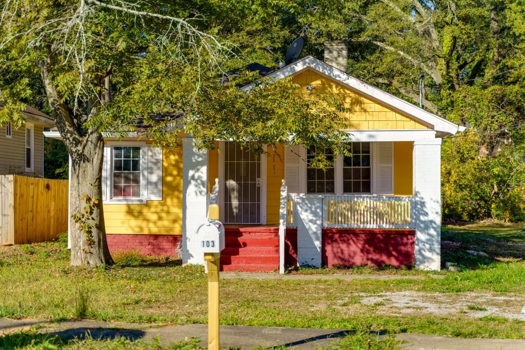 a view of house with yard