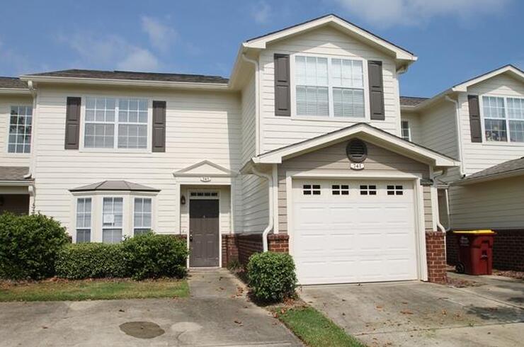 a front view of a house with a yard