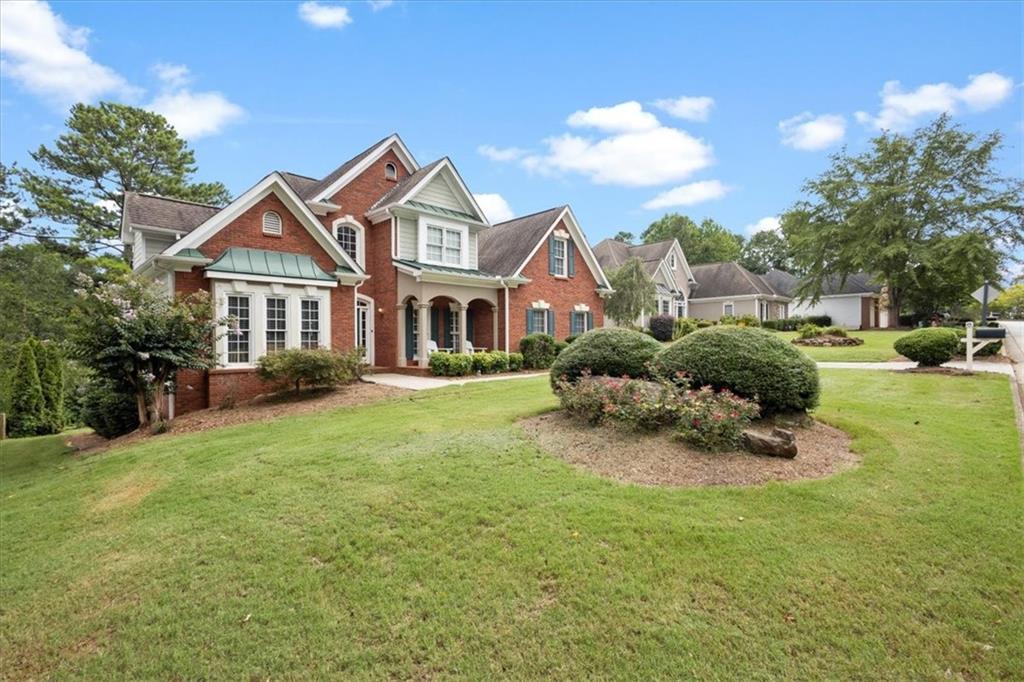 a front view of a house with garden