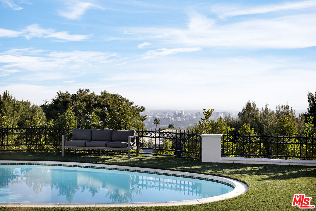 a view of swimming pool with a yard and sitting area