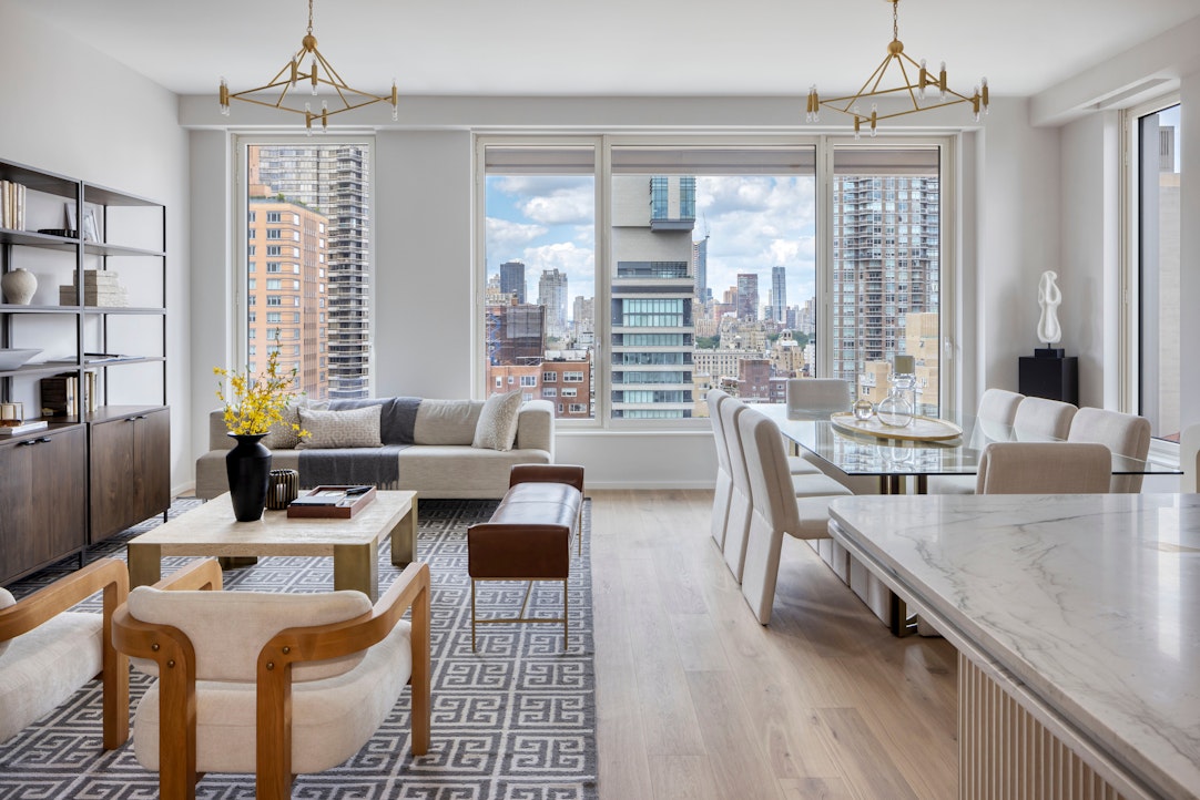 a dining room with furniture a chandelier and wooden floor