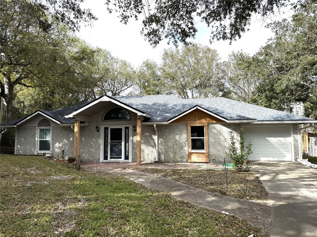 a view of a house with yard and a garden