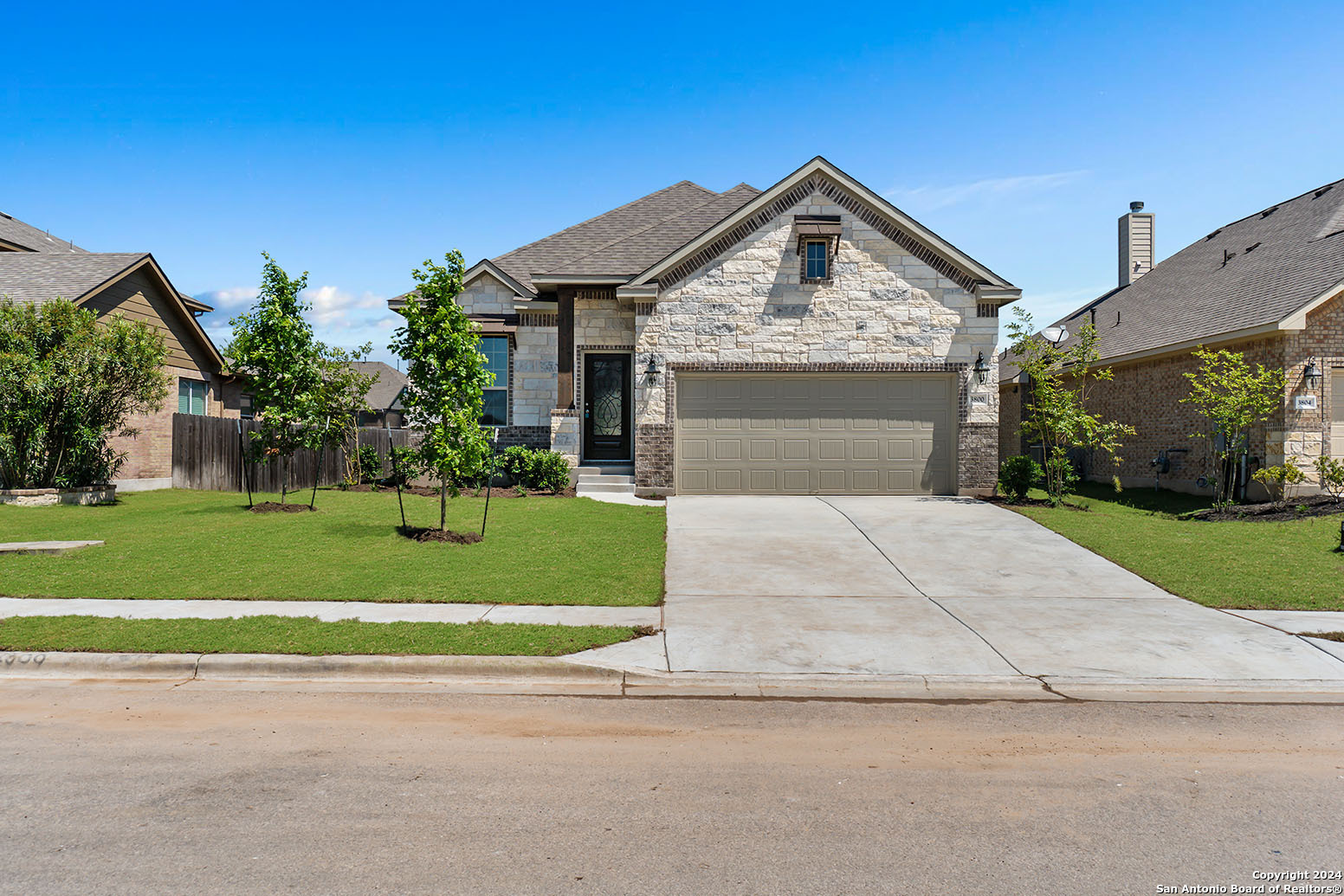 a front view of a house with a yard and garage