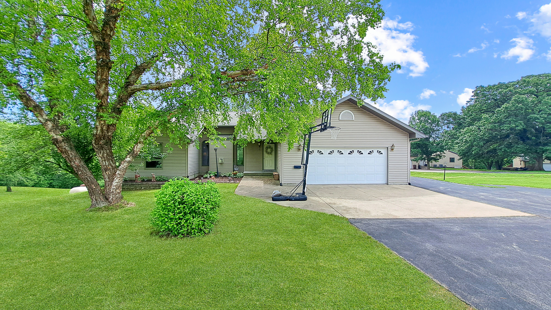 a view of a house with a yard and tree